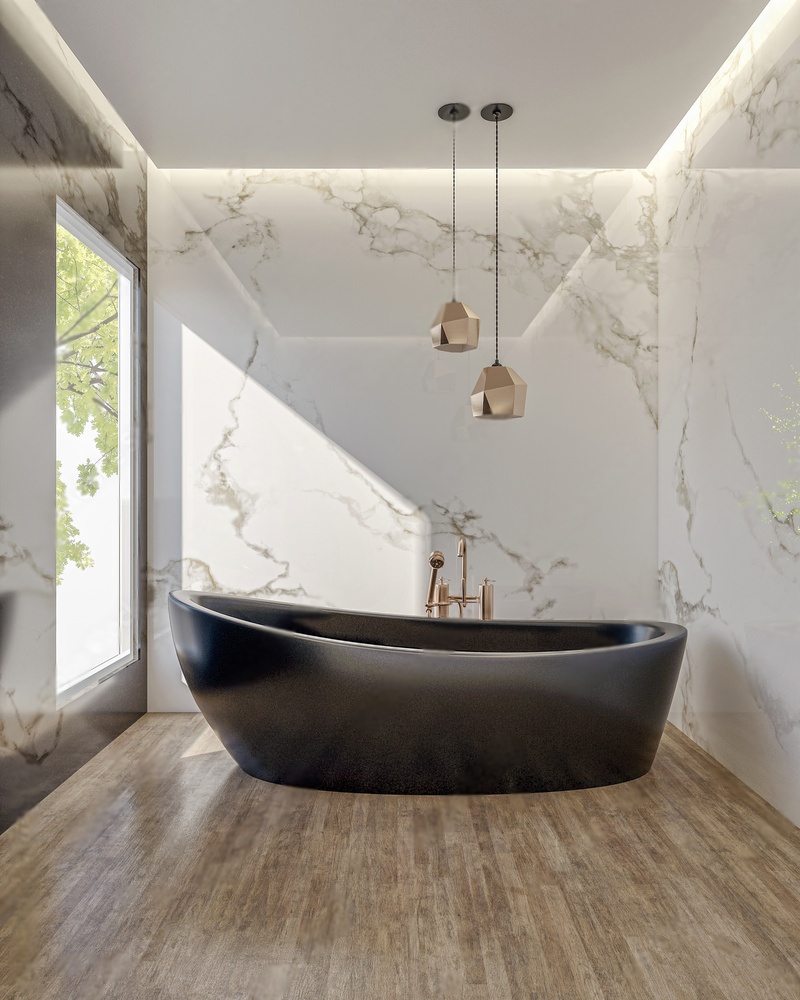 Marble walled bathroom with black bathtub and golden fixtures